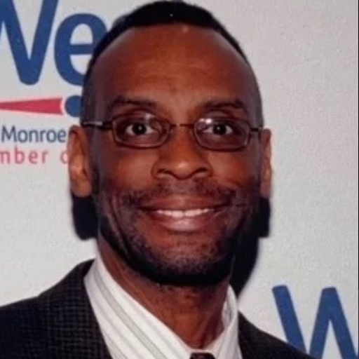 Louis Garrett is an African-American man. He is wearing glasses.